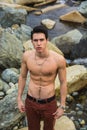 Athletic shirtless young man outdoor at river or water stream Royalty Free Stock Photo