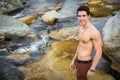 Athletic shirtless young man outdoor at river or water stream Royalty Free Stock Photo