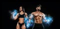 Muscular fitness sports man and fit woman, atletes with dumbbell in fitness gym. Energy and power.