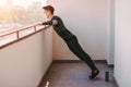 Athletic sports man doing push ups exercise on balcony at home Royalty Free Stock Photo