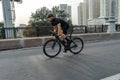 Athletic sportsman riding professional bike in race on a road. Royalty Free Stock Photo