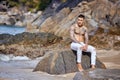 Athletic sporty guy posing on a tropical beach Royalty Free Stock Photo