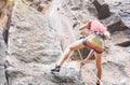 Athletic strong man climbing a rock wall - Climber performing on a canyon mountain