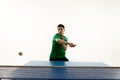 Athletic table tennis stance from competitive Asian sportsman, player in sportswear in motion against white studio