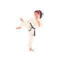 Athletic taekwondo sportswoman in kimono presenting strength and skills on sportive training