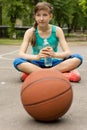 Athletic teenage girl drinking bottled water Royalty Free Stock Photo