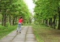 Athletic teenage girl roller skating in a park Royalty Free Stock Photo