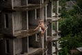 Athletic topless man balancing on a slackline on rainy day