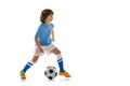 Young sportsman, football soccer player, child playing football isolated on white studio background. Concept of sport Royalty Free Stock Photo