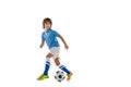 Young sportsman, football soccer player, child playing football isolated on white studio background. Concept of sport Royalty Free Stock Photo