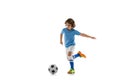 Young sportsman, football soccer player, child playing football isolated on white studio background. Concept of sport Royalty Free Stock Photo