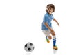 Young sportsman, football soccer player, child playing football isolated on white studio background. Concept of sport Royalty Free Stock Photo