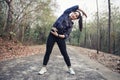 Athletic woman asia warming up and Young female athlete exercising and stretching in a park before Runner outdoors, healthy Royalty Free Stock Photo