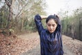 Athletic woman asia warming up and Young female athlete exercising and stretching in a park before Runner outdoors, healthy Royalty Free Stock Photo