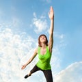 Athletic woman balancing in front of blue sky Royalty Free Stock Photo