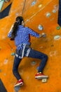 Athletic woman climbing indoors, view from the back Royalty Free Stock Photo