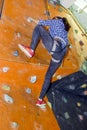 Athletic woman climbing indoors, view from the back Royalty Free Stock Photo