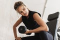 Athletic woman doing bicep curl exercise with a dumbbells in the gym Royalty Free Stock Photo