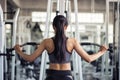 woman exercise by pumping back in gym