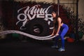 Athletic woman doing some crossfit exercises with a heavy rope Royalty Free Stock Photo