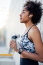 Athletic woman drinking water after work out outdoors. Royalty Free Stock Photo