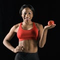 Athletic woman holding apple. Royalty Free Stock Photo