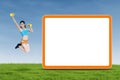 Athletic woman jumps next to empty board Royalty Free Stock Photo