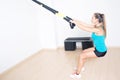 Athletic woman makes TRX exercise