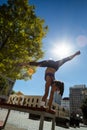 Athletic woman performing handstand and doing split on bench Royalty Free Stock Photo