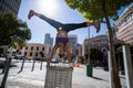 Athletic woman performing handstand and doing split on bin Royalty Free Stock Photo