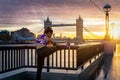 A athletic woman performs her stretches during sunrise in the city