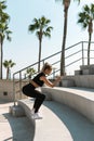 Athletic woman is running on concrete stairs during her street summer workout Royalty Free Stock Photo