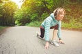 Athletic woman running in countryside road. Fitness female runner in ready start line pose outdoors in summer sprint Royalty Free Stock Photo