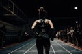 Athletic woman running on a track and field at night, A runner sprinting in a competitive race, AI Generated