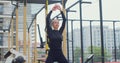 Athletic woman shape jump on sports ground. Jumping motion with raise hands hard cardio workout. Physical training