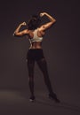 Athletic woman showing back and biceps muscles Royalty Free Stock Photo