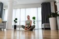 Athletic woman in sportswear doing fitness stretching exercises at home in the living room. Sport and recreation concept. Home Royalty Free Stock Photo