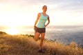 Athletic woman stretching outdoors by sunset Royalty Free Stock Photo