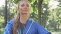 Athletic woman stretching in the park before her morning workout Royalty Free Stock Photo