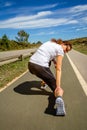 Athletic woman suffering pain in leg calf by cramp