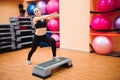 Athletic woman trainer doing aerobic class with steppers. Sport Royalty Free Stock Photo