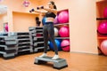Athletic woman trainer doing aerobic class with steppers. Sport Royalty Free Stock Photo
