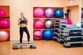 Athletic woman trainer doing aerobic class with steppers. Sport Royalty Free Stock Photo