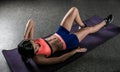 Athletic woman working ab intervals in fitness.