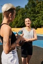 Athletic woman hydrates with water while