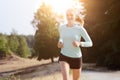 Athletic young blonde woman jogging, running and training outdoors on a sunny day in summer Royalty Free Stock Photo