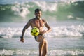 Athletic Young Brazilian Man Juggling Football Beach