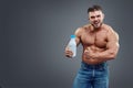 Athletic young handsome man with white shake bottle.