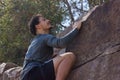 Athletic young man climbing up on rock wall outdoors Royalty Free Stock Photo