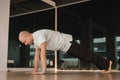 An athletic young man does exercises in the fitness room. A professional guy does yoga in the gym Royalty Free Stock Photo